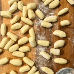 Ricotta gnocchi uncooked on wood cutting board