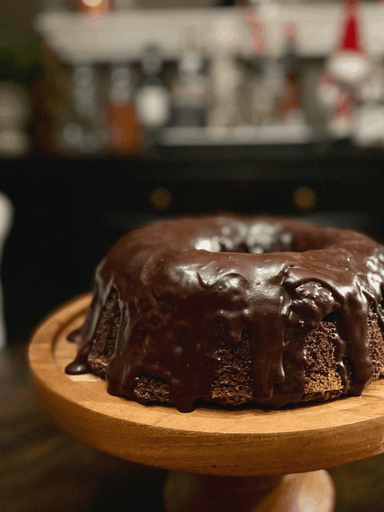 chcolate bundt cake on wooden cake stand