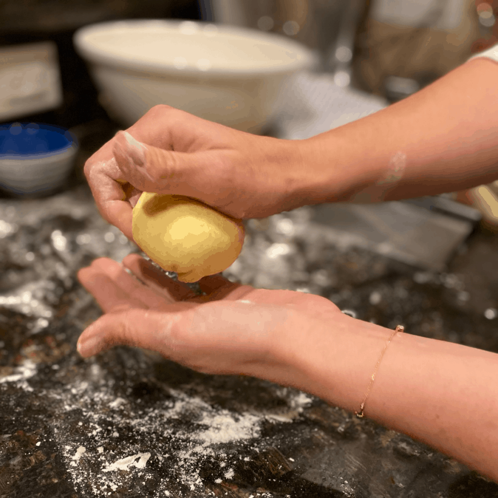 hands shaping dough ball