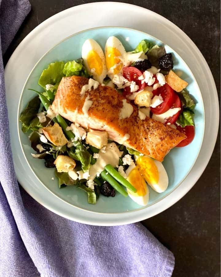 salmon salad on blue and white plate with napkin
