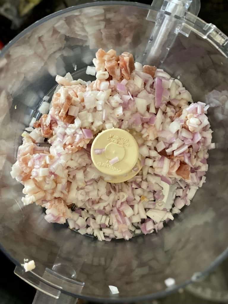diced bacon and diced shallot in bowl of food processor