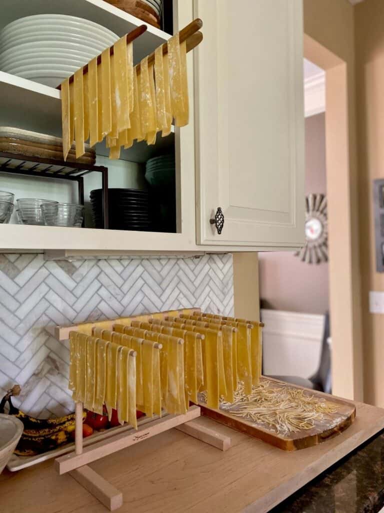 pasta drying on racks in kitchen