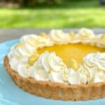 lemon tart with almond crust on blue plate