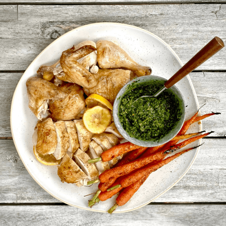 pan roasted chicken with herbs salsa and carrots on table