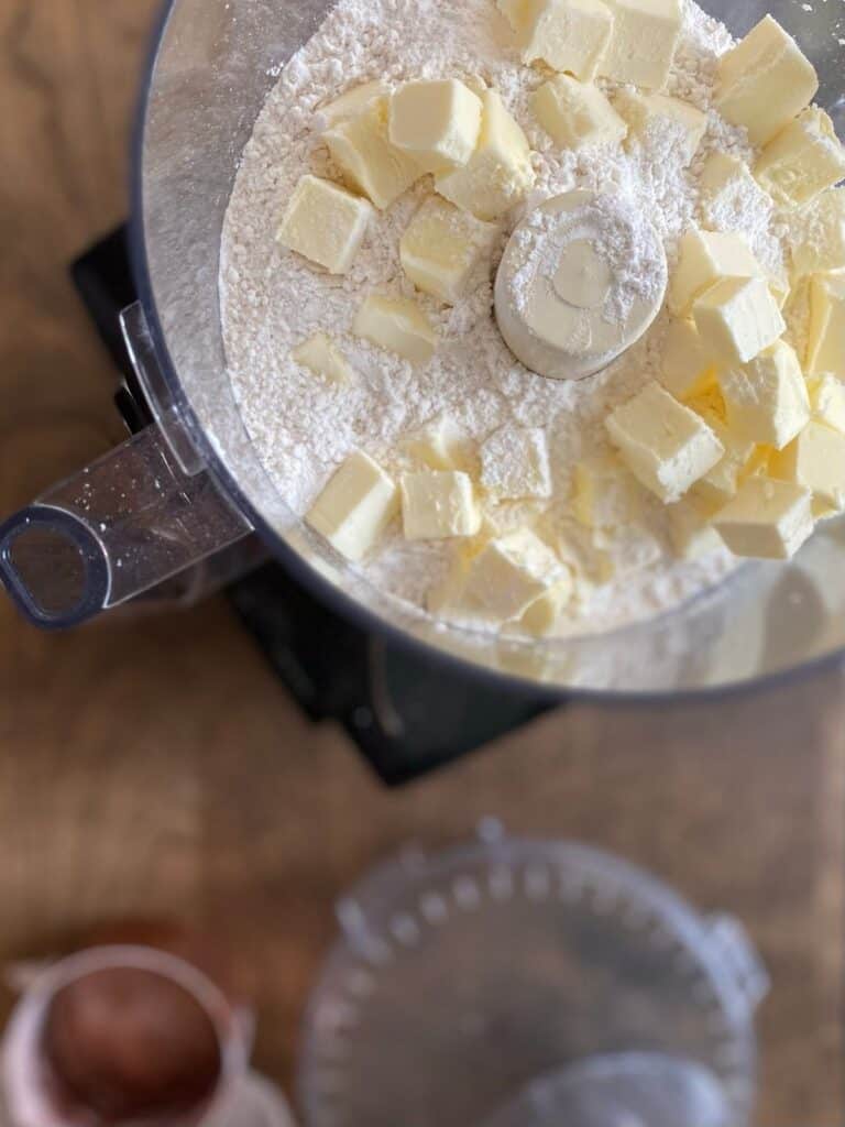 cubed butter and flour in food processor bowl
