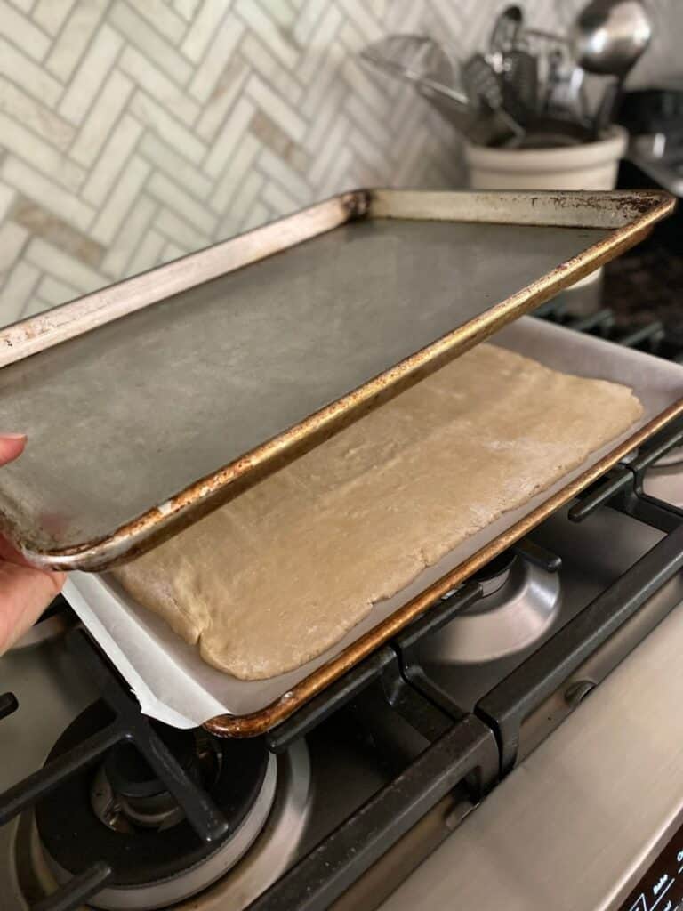 placing pan on top of dough