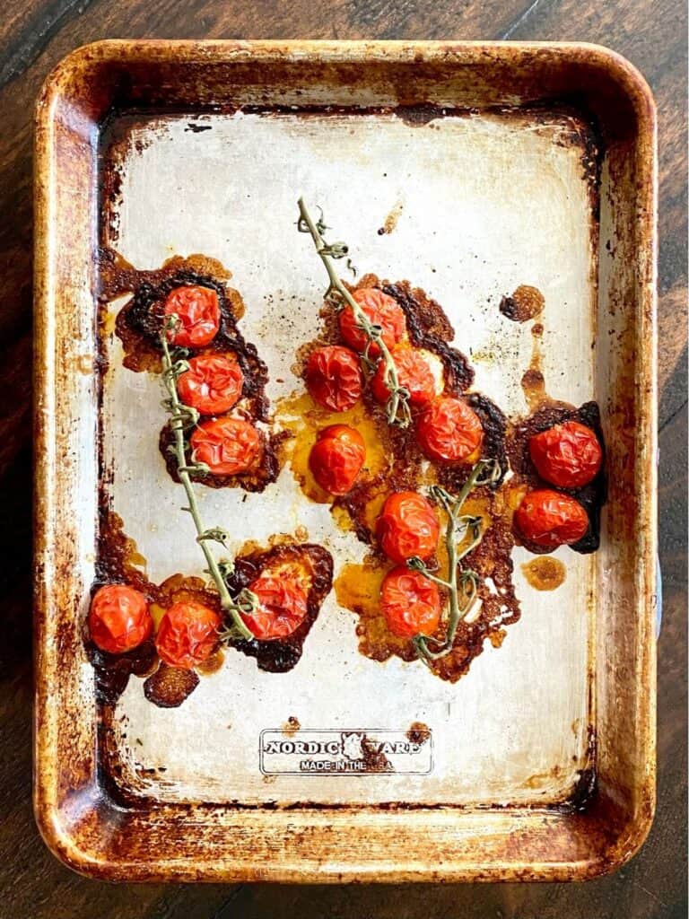 low roasted cherry tomatoes on baking sheet