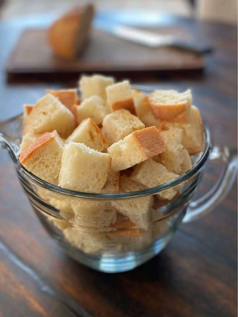measuring cup filled with bread cubes