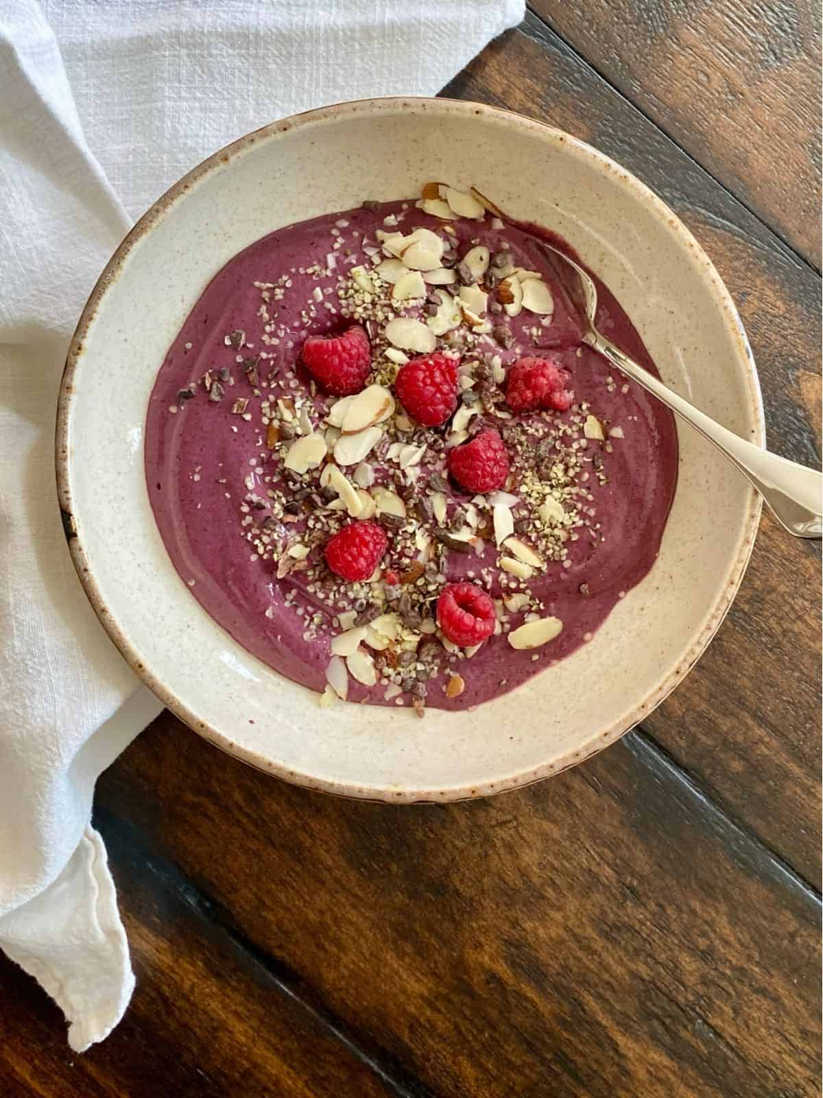 glow smoothie bowl with spoon on wood table
