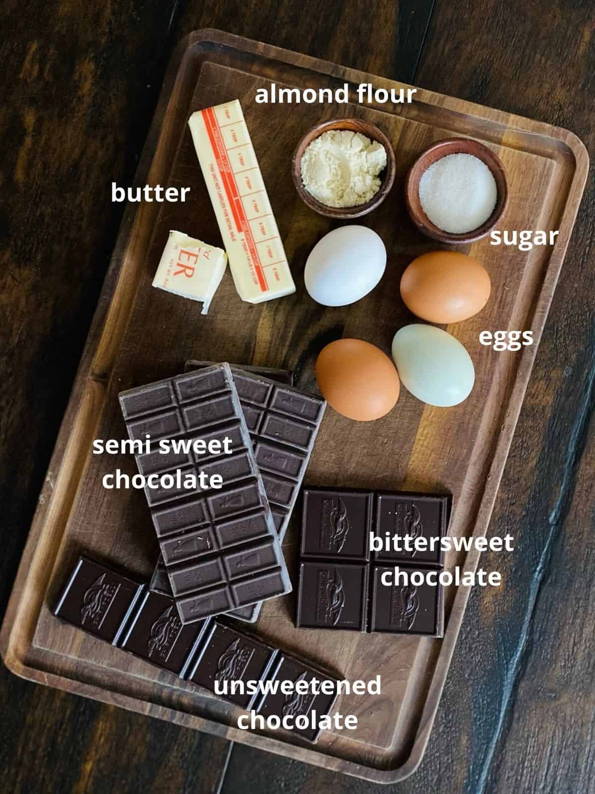ingredients for french chocolate cake on wood background