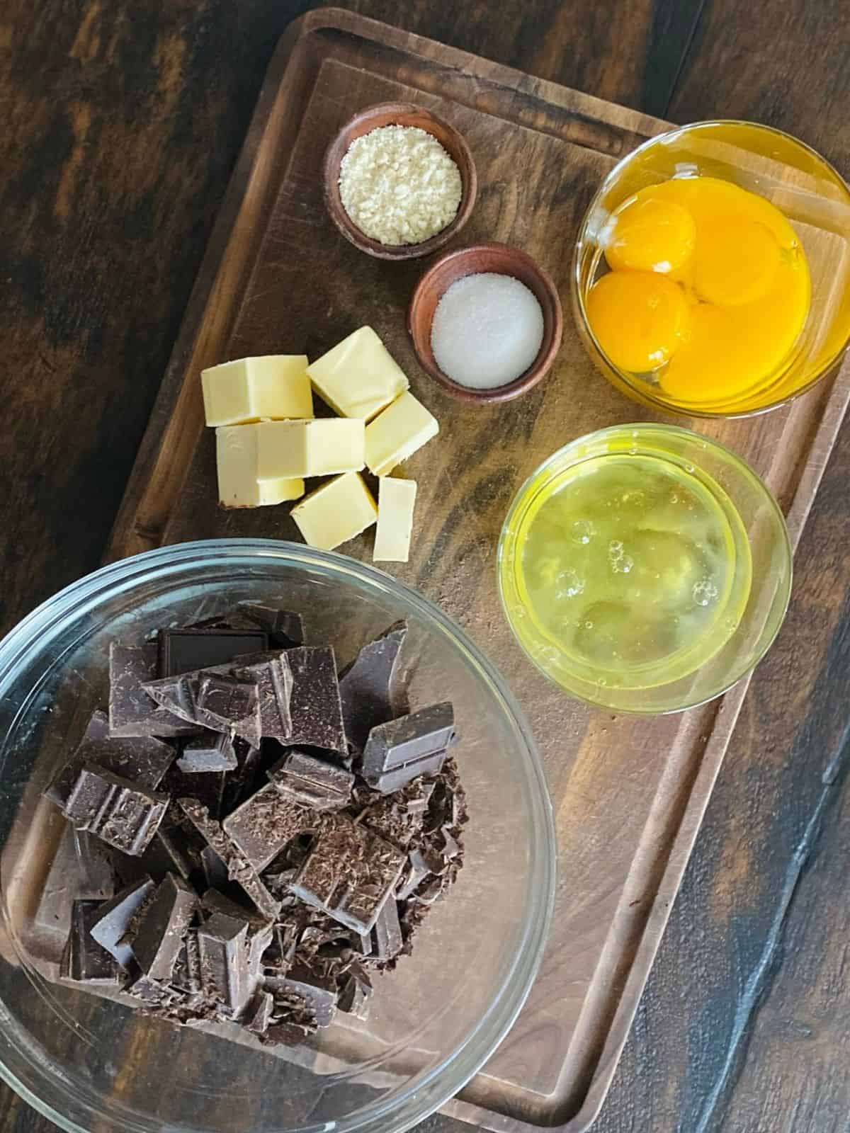 prepped ingredients for french chocolate cake on wood background