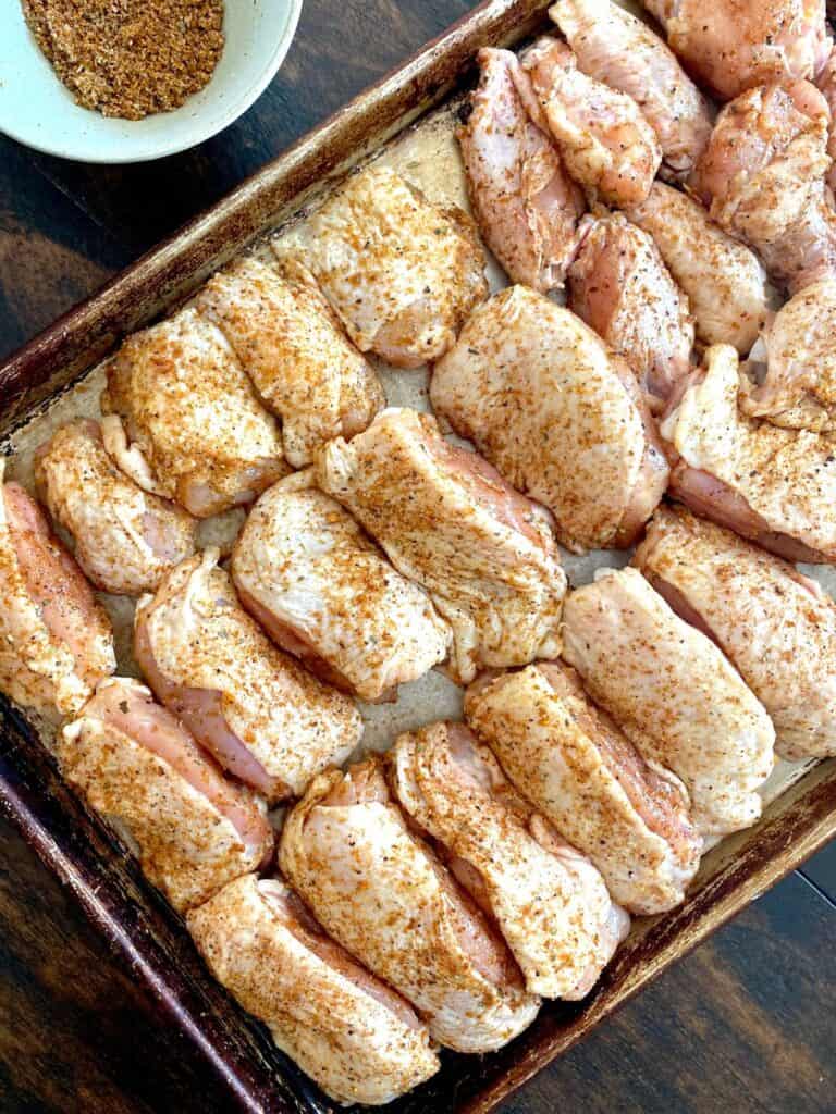 chicken coated in citrus rub on sheet pan