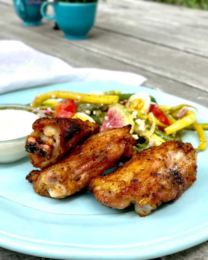 citrus rubbed chicken wings with feta cream and garden bean salad on blue plate (1)
