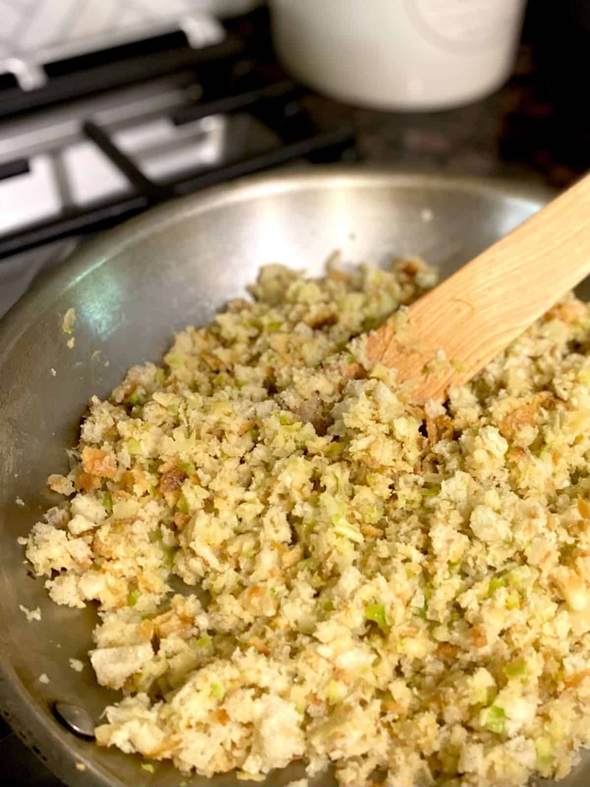 stirring sourdough crumbs into celery and onion