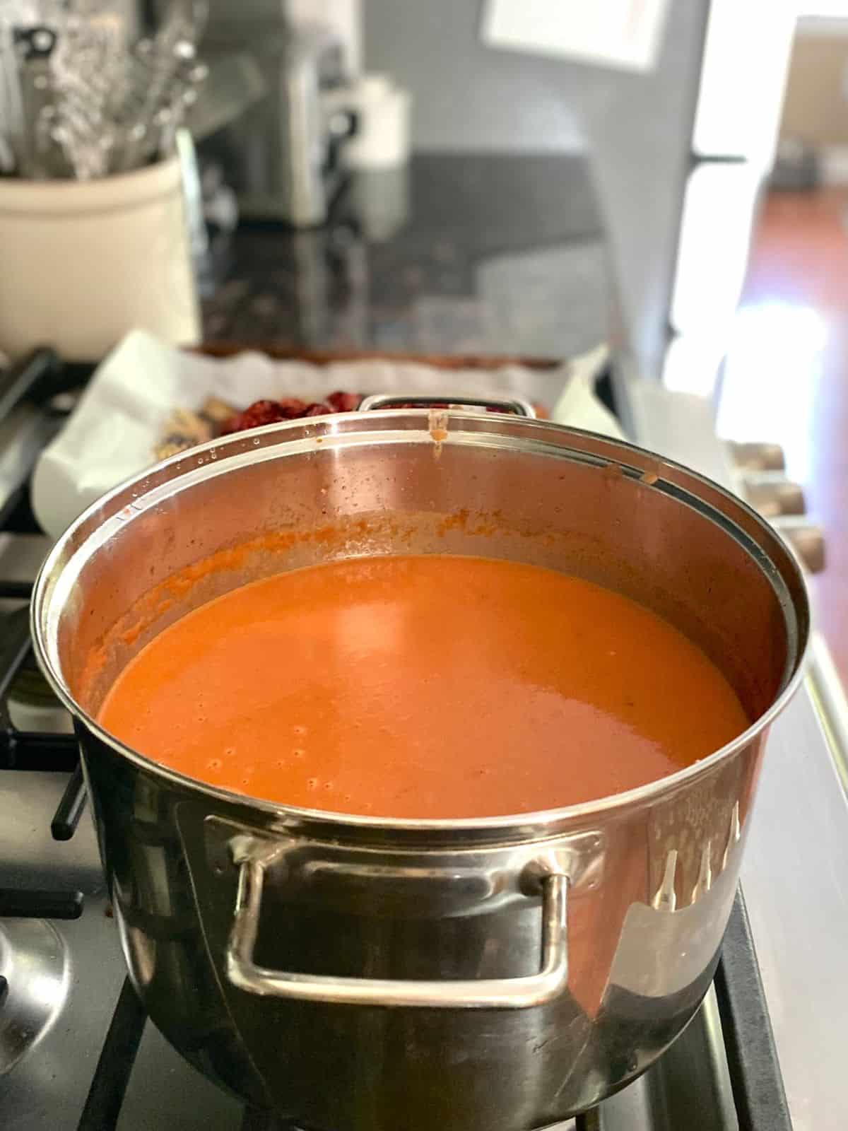pot of tomato soup after smoothing with immersion blender